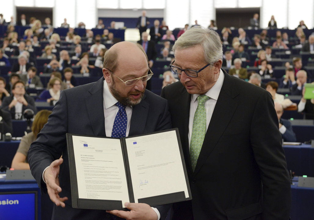Martin Schulz y Jean-Claude Juncker sostienen el certificado de nombramiento tras el pleno.