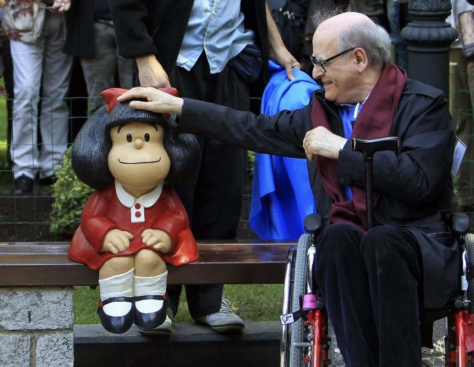 Quino toca la cabeza de Mafalda, sentada en un banco frente al estanque del Campo de San Francisco.
