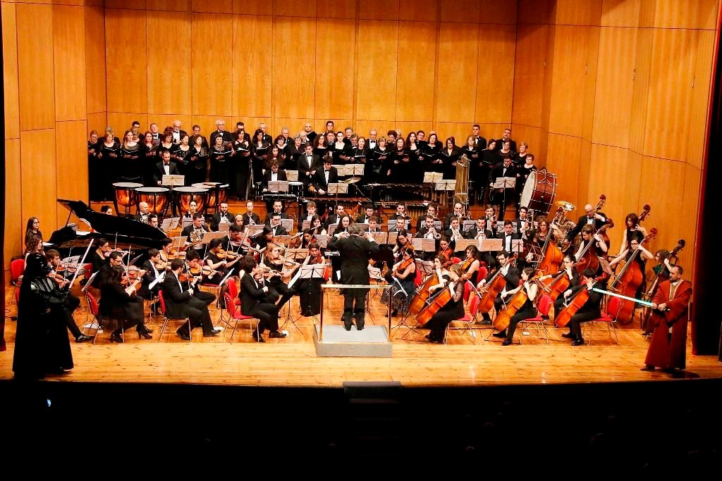 La Orquesta Clásica durante su interpretación de los temas principales de Star Wars, con Darth Vader y Obi Wan en la escena.