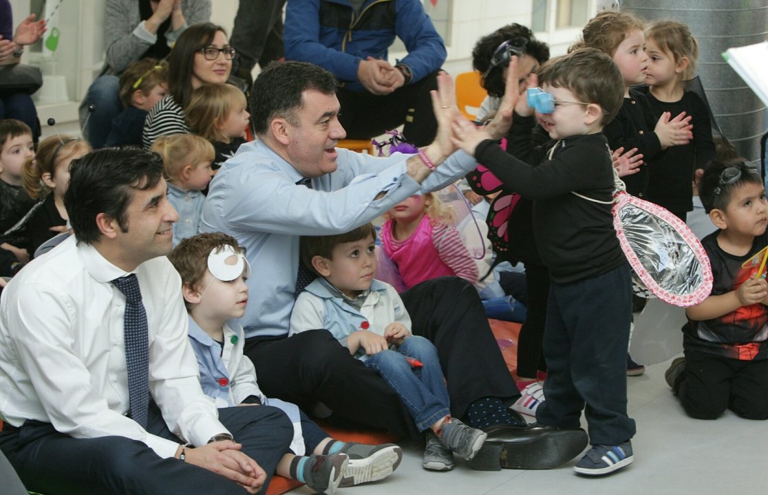 O conselleiro de Cultura, Román Rodríguez, xoga cun neno na compaña do de Política Social, José Manuel Rey.