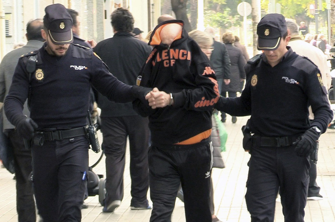 La policía traslada al detenido por la muerte de una mujer en Valencia.
