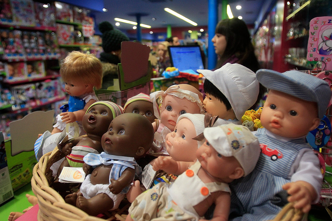 Cesta con muñecos de varios tipos en la entrada de una tienda de juguetes.
