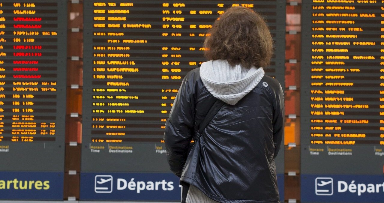 Una viajera observa el panel informativo del aeropuerto Charles de Gaulle.