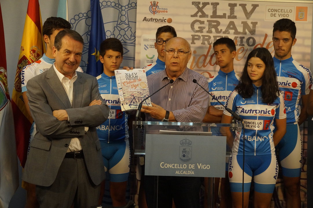 Carlos Vidal, del Vigués Autronic, muestra la revista oficial acompañado por Caballero, en la presentación.