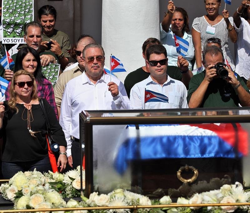 El hijo mayor del líder cubano Fidel Castro, Fidel Castro Díaz-Balart (c-i), y a su hijo Fidel (c-d), mientras observan la urna con las cenizas de su padre y abuelo, respectivamente, en La Habana
