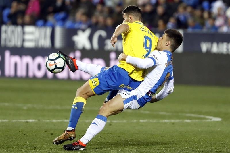 El delantero argentino de Las Palmas Jonathan Calleri (I) protege el balón ante Bustinza, del Leganés