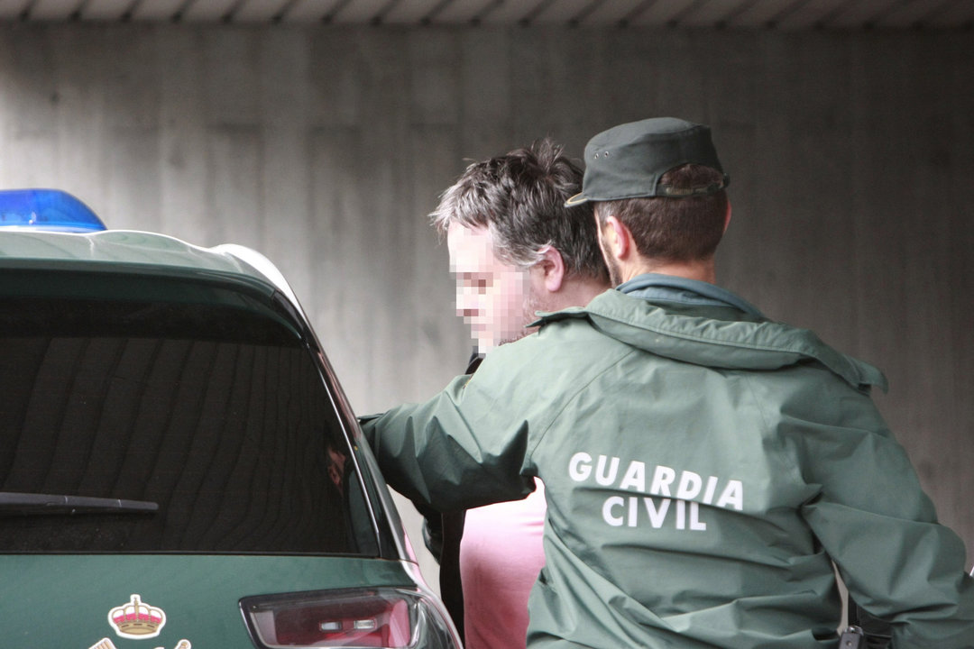 Marcos Mirás, custodiado por un agente, a la salida de los juzgados de A Coruña.