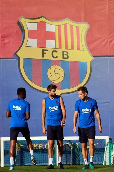 Piqué y Rakitic, ayer, en el entrenamiento del Barcelona.