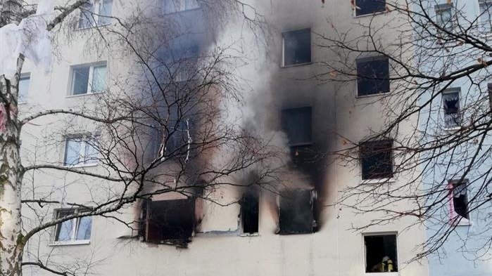Fachada del edificio con una columna de humo saliendo de las ventanas de una vivienda de la segunda planta