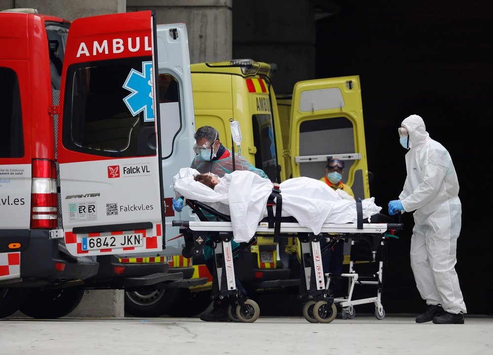 Personal sanitario recibe a una enferma en la entrada de Urgencias del Hospital de Bellvitge, en Barcelona