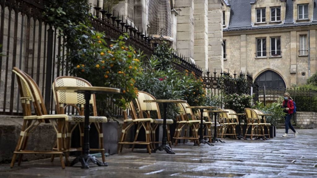 Una terraza de un bar en una calle semivacía en el centro de París, tras el anuncio del toque de queda en la región.