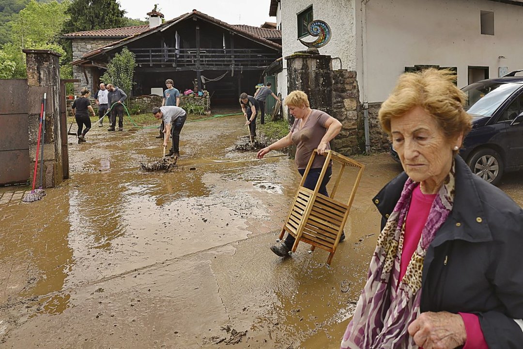 Vecinos de Bera (Navarra) se afanaban ayer en limpiar tras el desbordamiento del río Zia.