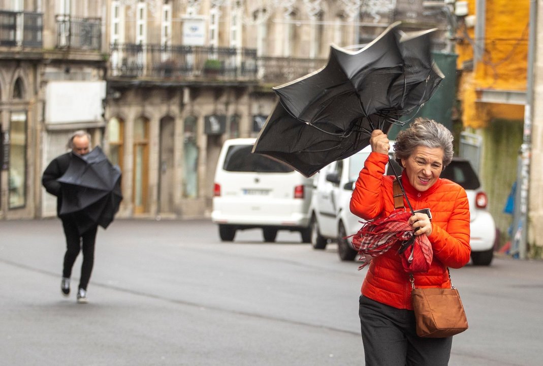 El viento vence al paraguas con fuertes ráfagas en Vigo.