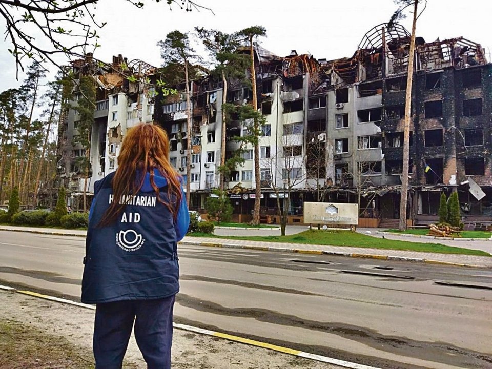 Una voluntaria de una ONG observa la destrucción en una ciudad ucraniana.