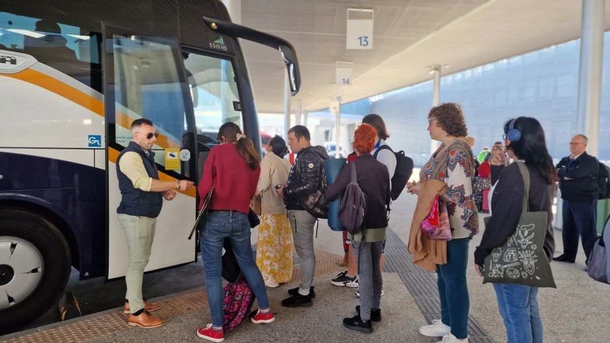 Pasajeros tomando ayer el autobús con destino al aeropuerto de Santiago en la estación de Urzaiz.